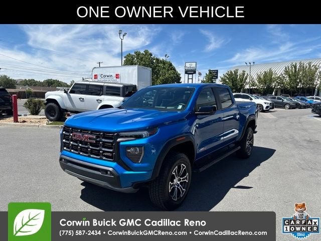 2023 GMC Canyon AT4 in Dynamic Blue Metallic — front three-quarter view
