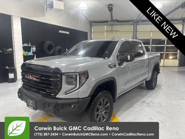 2024 GMC Sierra 1500 AT4X in Thunderstorm Gray — front three-quarter view